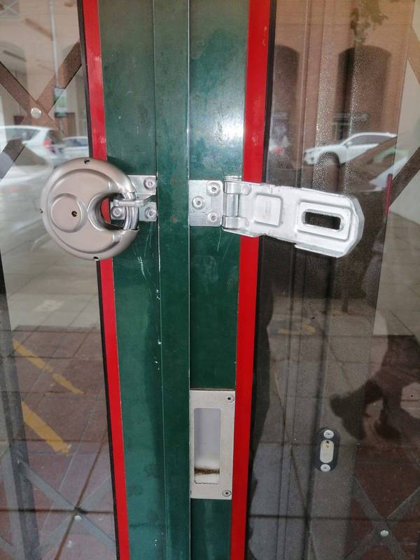Heavy-duty hasp and padlock installed on commercial gate